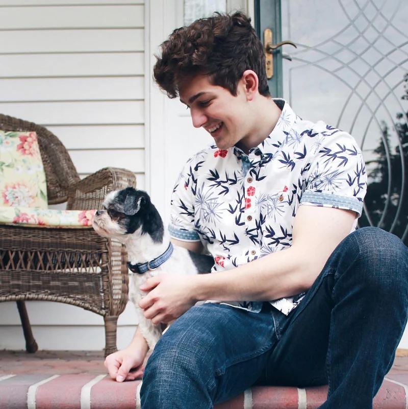 Matt sitting on a porch with Bandit as a puppy