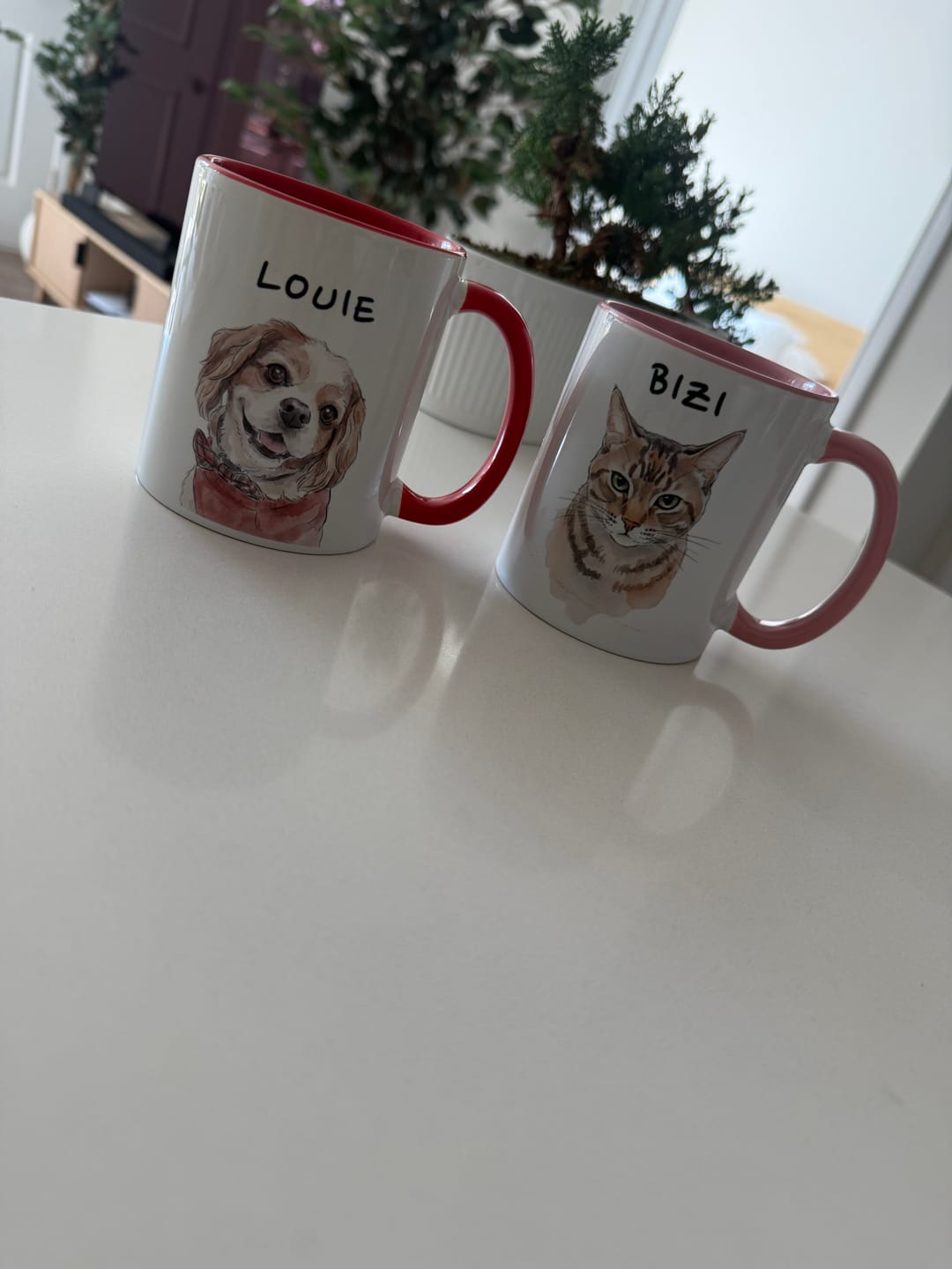 Two pink-handled mugs with a dog and cat portrait