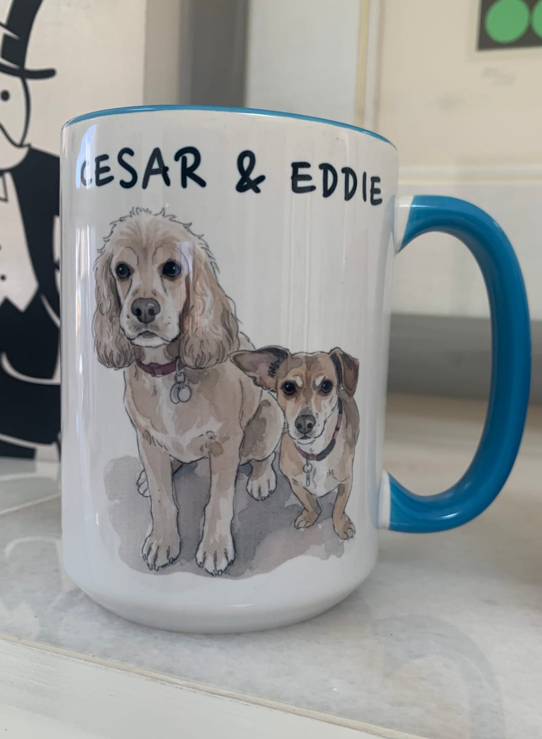 Blue-handled mug with Cesar and Eddie dog portraits